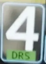 Close-up from the still: a badge under the number